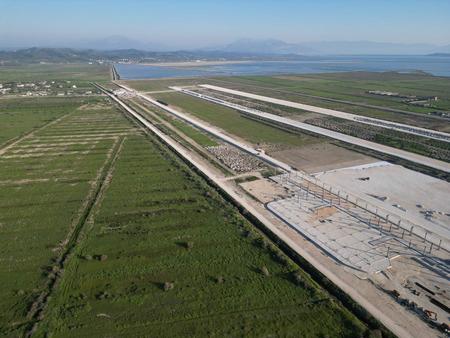 The construction site of Vlora Airport in the Narta Lagoon. Runways and the foundations of the airport building are already visible.