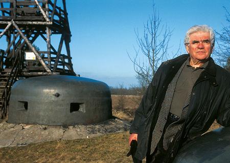 Eugen Nowack in front of a Bunker and a watch tower