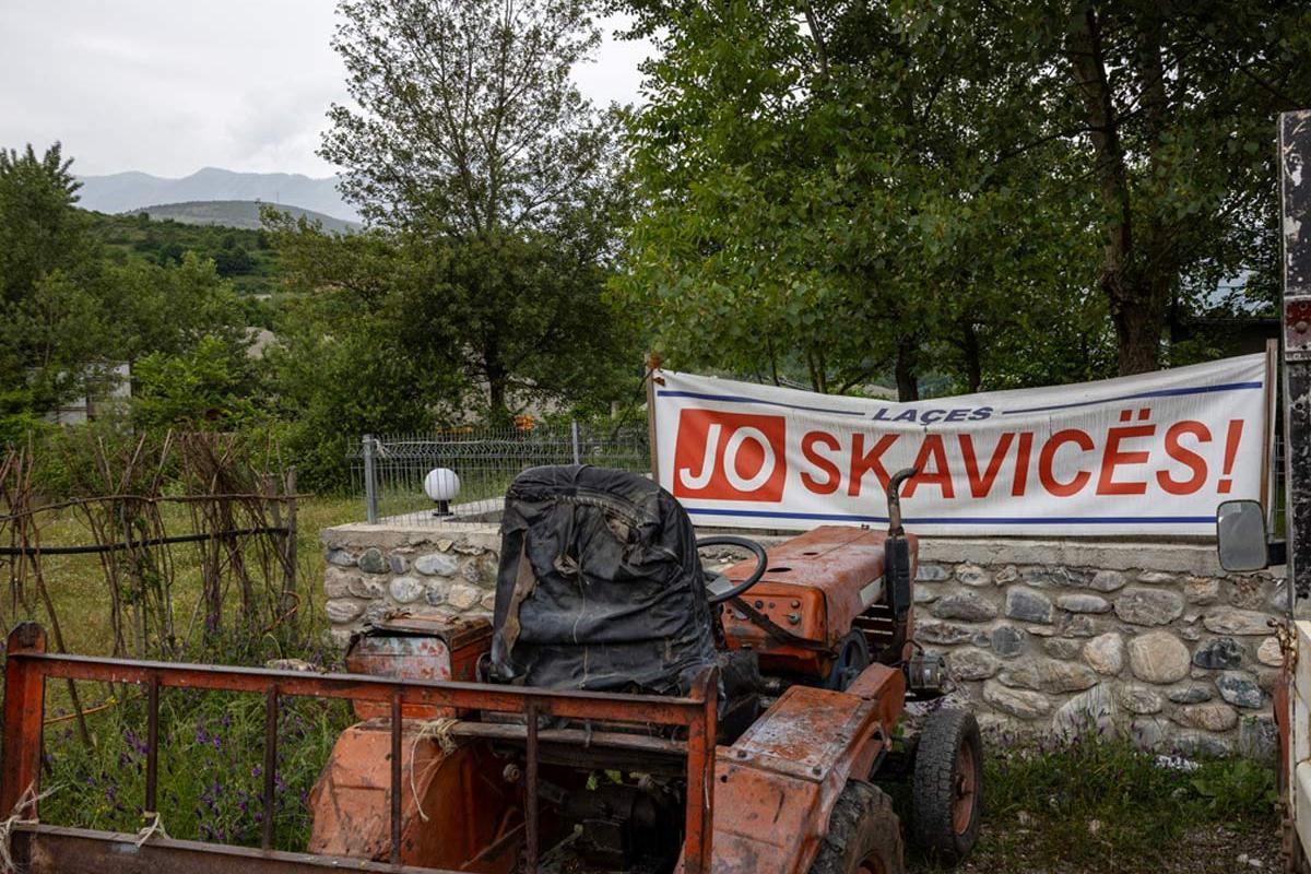 A protest banner against the Skavica dam hangs in a village in the Dibra Valley.