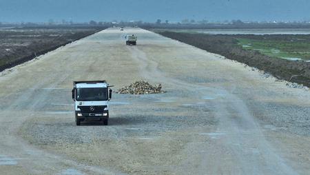 Trucks on the construction site of Vlora Airport in the Narta Lagoon